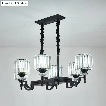 Modern black ceiling light with five clear ribbed glass shades and twisted chains for adjustable cord length suspension