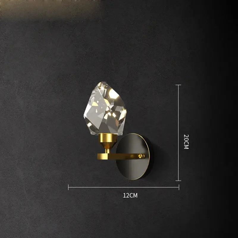 A sleek gold-toned wall sconce with a faceted crystal gemstone in decorbites black crystal copper led style