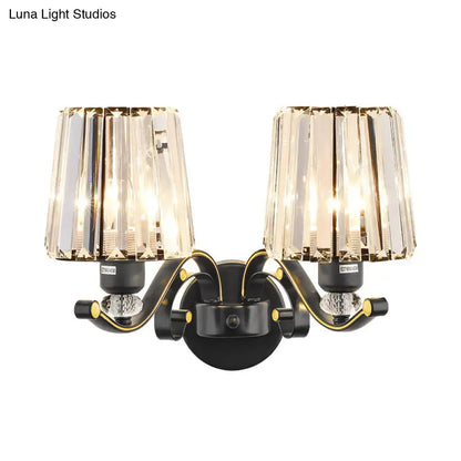 Modern black and gold two-light wall light with faceted crystal design shades for living room use