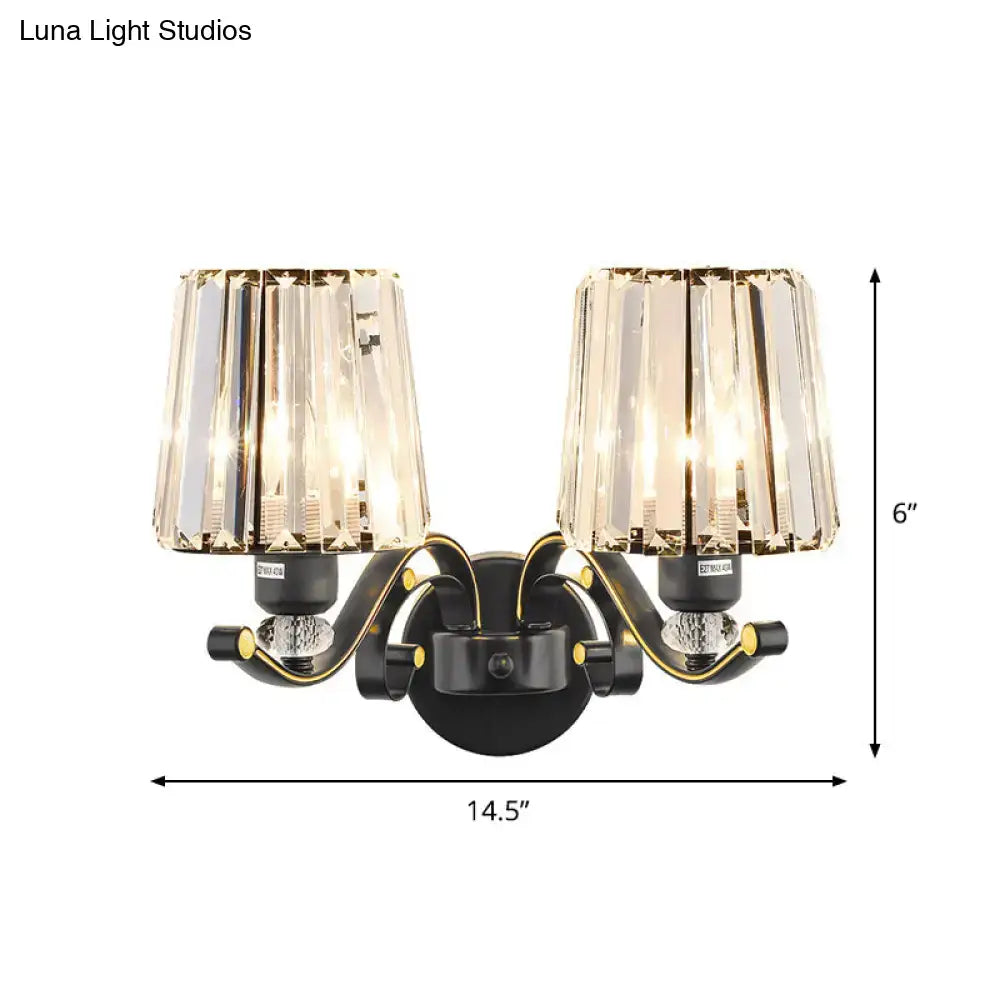 Modern black and gold two-light wall light with faceted crystal design shades for living room illumination