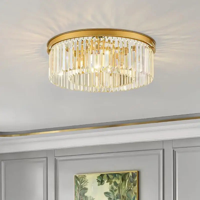 Modern black crystal flush mount ceiling light with gold-toned frame and cascading clear crystal prisms for dining room