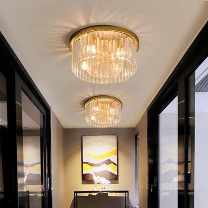 Modern black crystal flush mount ceiling light features a gold-toned crystal chandelier with clear glass rods and warm lighting