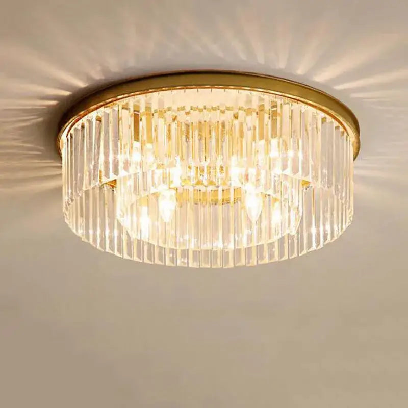Modern black crystal flush mount ceiling light with gold-toned frame and cascading clear crystal prisms for dining room