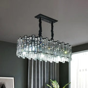 Elegant oval crystal island pendant light with black twisted metal arms for modern dining room lighting