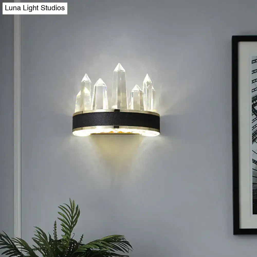 Modern black crystal led wall sconce with icicle shaped quartz pillars on a sleek black and gold shaped wall mount
