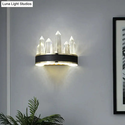 Modern black crystal led wall sconce with icicle shaped quartz pillars on a sleek black and gold shaped wall mount