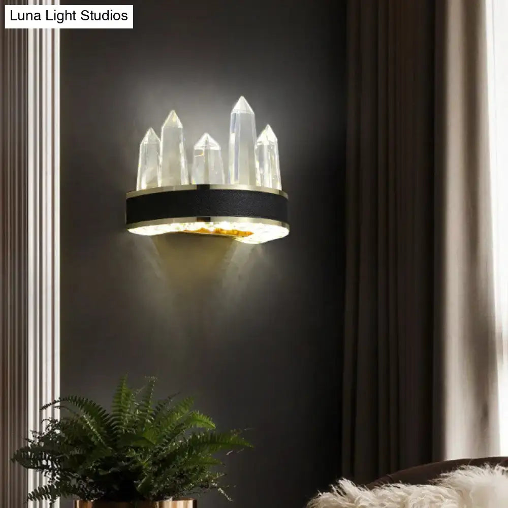 Modern black crystal led wall sconce with icicle shaped quartz spikes and gold base for ambient living room lighting