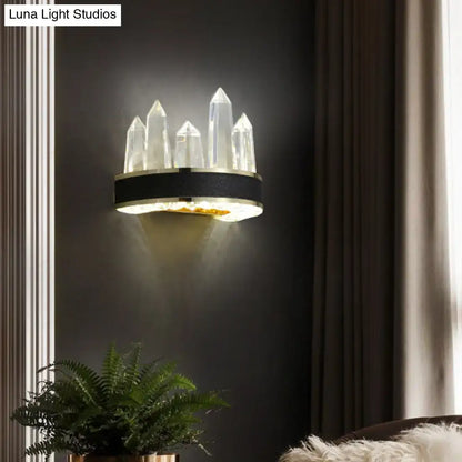 Modern black crystal led wall sconce with icicle shaped quartz spikes and gold base for ambient living room lighting
