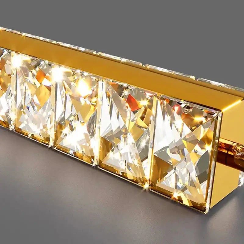 Modern black crystal pendant light with gold-toned rectangular wall sconce and faceted crystal panels for stairwell lighting