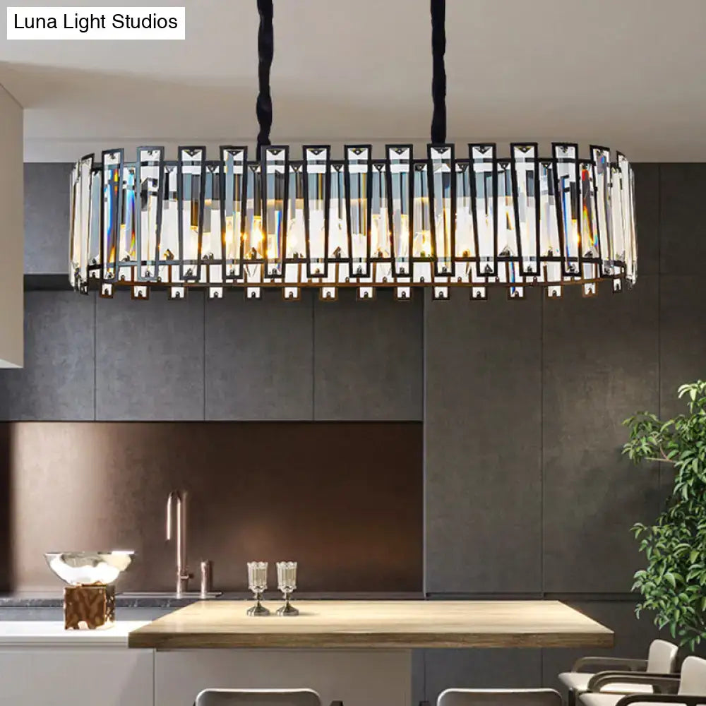 A modern black crystal prism island pendant with vertical prisms in metal frame for dining room lighting