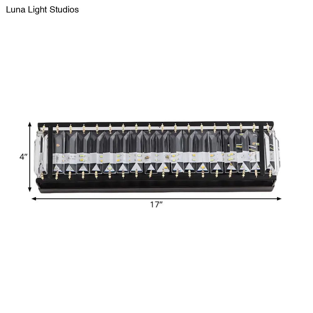 Modern black crystal rectangular sconce with clear faceted covers and gold-colored mounting hardware for bedroom wall lighting