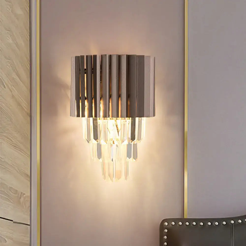 Modern black crystal wall light with vertical metallic slats and cascading crystal prisms for bedroom use