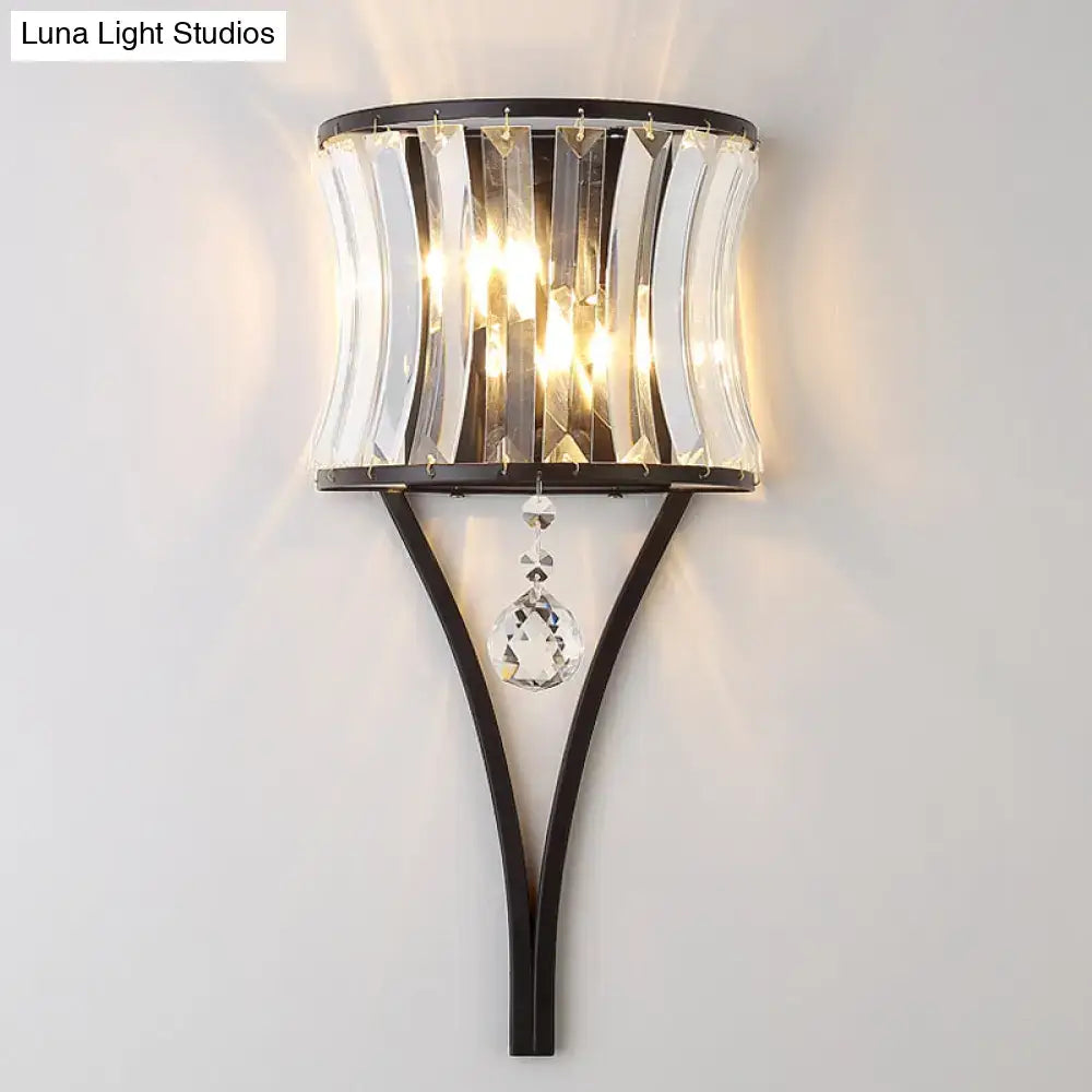 A sleek black metal wall lamp with vertical crystal prisms and a faceted pendant for wall mounted lighting