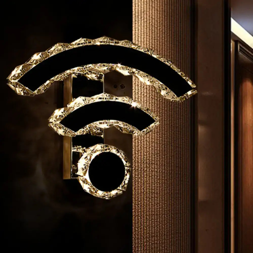 Golden intricately textured modern wall light shaped like a wi-fi symbol with warm white led light illumination