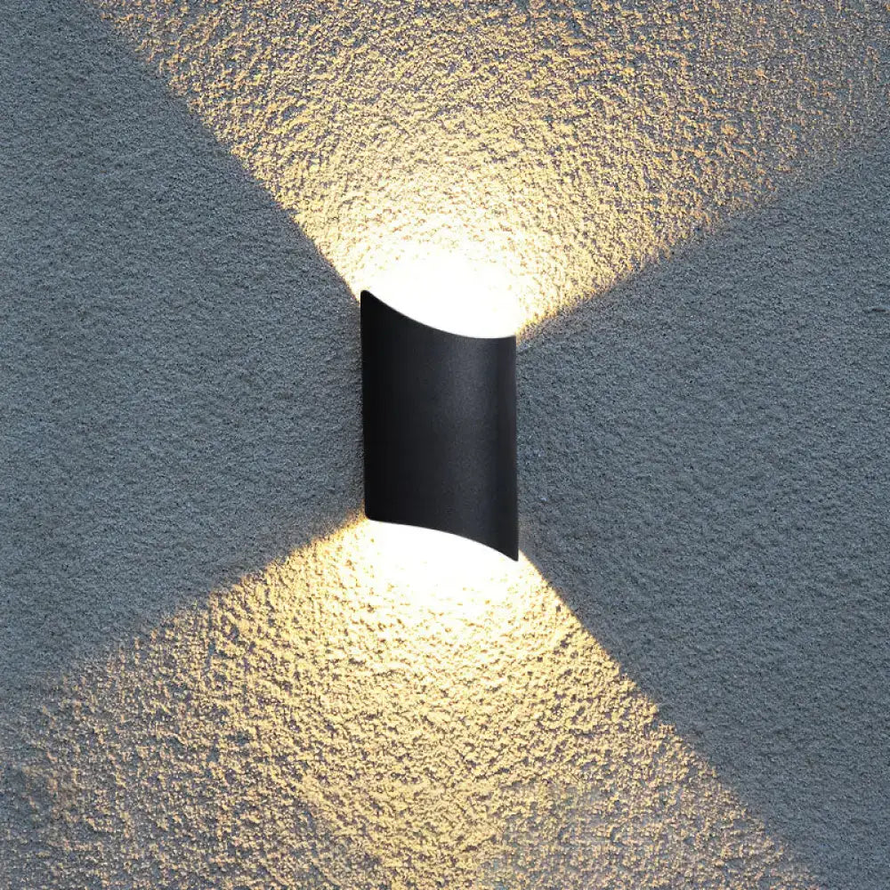 Modern black curved led wall lamp emitting warm directional light for yard outdoor use as a stylish wall lamp