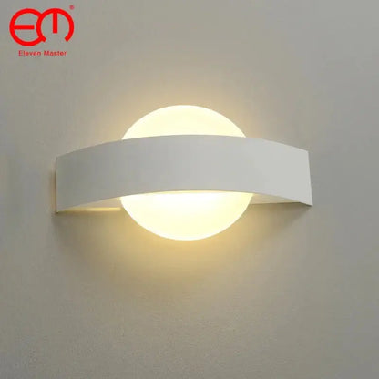 Modern black curved led wall light with white minimalist rectangular frame and circular frosted glass diffuser emitting warm light