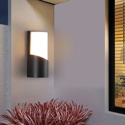 Modern black curved outdoor wall sconce with sleek design and warm white LED light for patio illumination