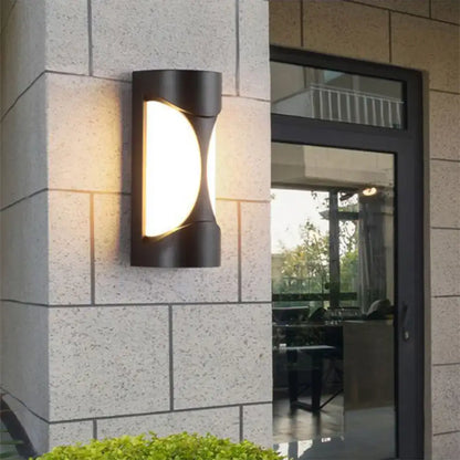 Modern black curved outdoor wall sconce with sleek design and warm glowing led light for patio lighting