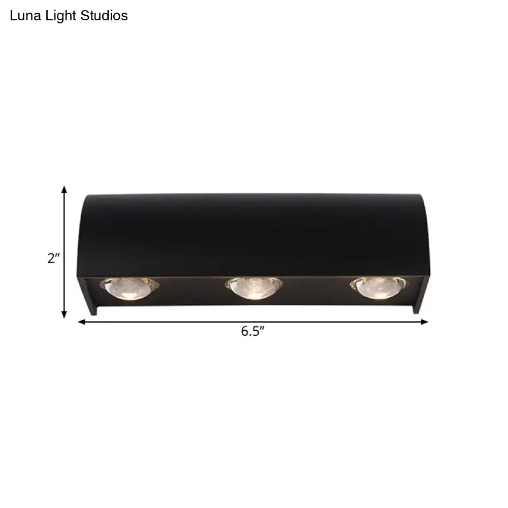 Modern black curved wall lamp with three circular minimalist led bulbs emitting warm white light for outdoor use
