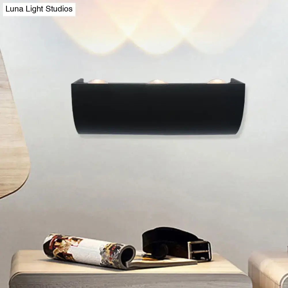 Black rectangular wall lamp with three integrated bulbs emitting warm white light minimalist led outdoor fixture