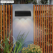 Modern black curved wall lamp outdoor minimalist led light fixture with sleek design emitting warm white light