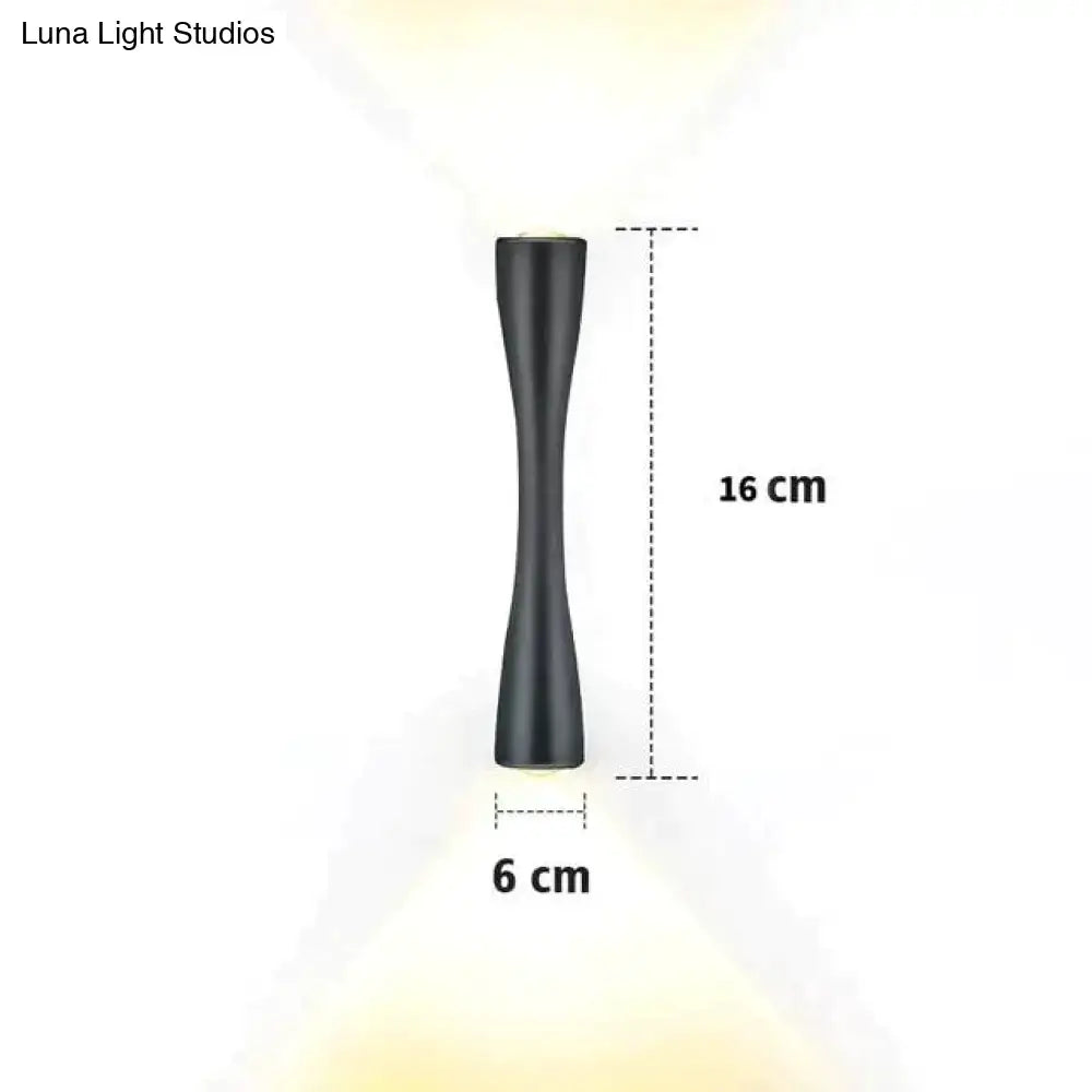 Modern black curved wall sconce with a sleek matte finish and hourglass silhouette for outdoor porch lighting