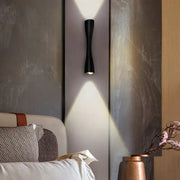 Modern black curved wall sconce with sleek design casting focused light for outdoor waterproof porch use