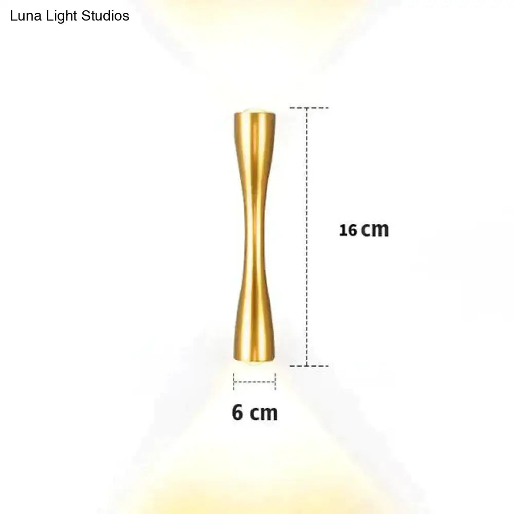 A sleek gold-colored brass wall sconce 16 cm tall with an hourglass shape for modern outdoor porch lighting