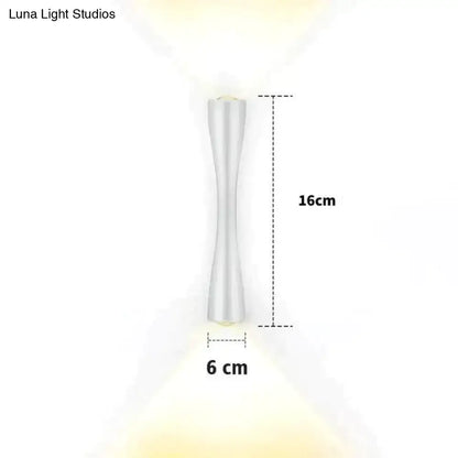 A sleek 16cm tall white led wall sconce with modern hourglass silhouette and smooth metallic finish for outdoor use