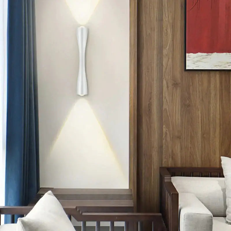 Modern black curved outdoor wall sconce with sleek sculpted design casting warm light for porch use