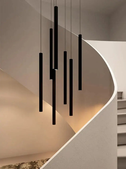 Modern black cylindrical led staircase chandelier with decorbites cylindrical led pendant lights above curved stairs