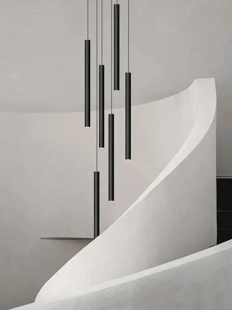 Modern black cylindrical led staircase chandelier with decorbites cylindrical led pendant lights in minimalist arrangement