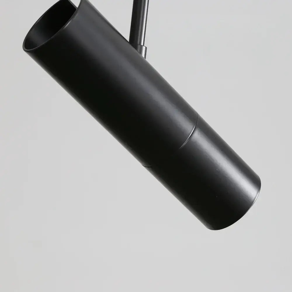 Modern black cylindrical pendant light with matte finish and adjustable spotlight ideal for bedroom decorbites black chandelier