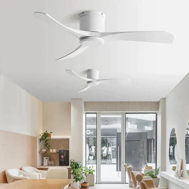 Modern black dc motor ceiling fan with sleek white curved blades and remote control for dining room use