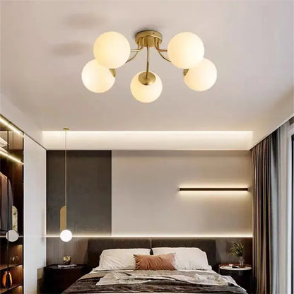 Gold-toned ceiling light with five frosted decorbites bubble glass globe shades for modern living room lighting