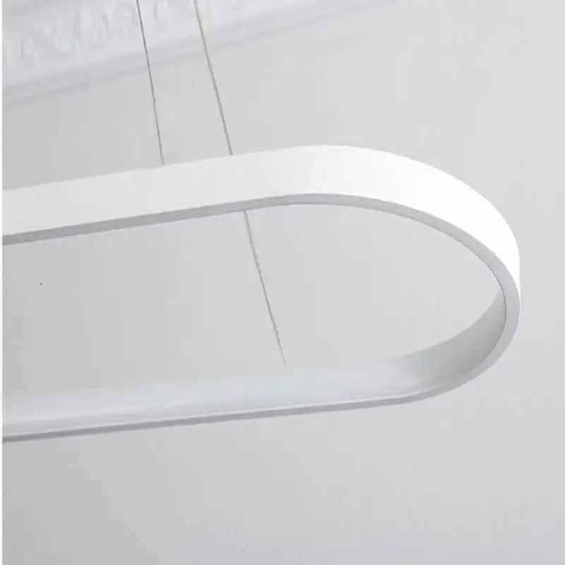 A sleek modern white led pendant lamp with a minimalist curved design by decorbites designer oval for dining room