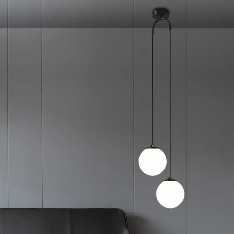 Modern black double glass ball pendant light with two frosted glass globes for bedroom ceiling illumination