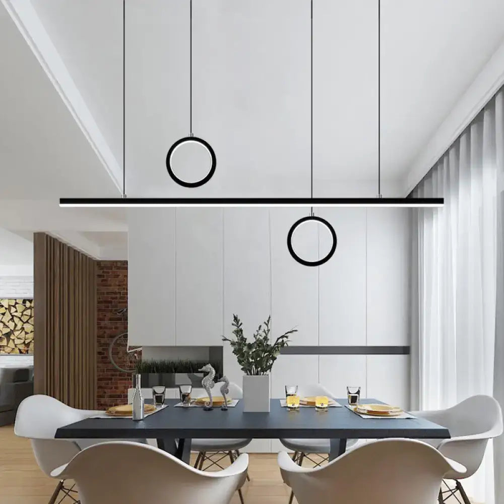 Modern black minimalist DecorBites™ Nordic dual ring LED acrylic island pendant light hanging in a dining room