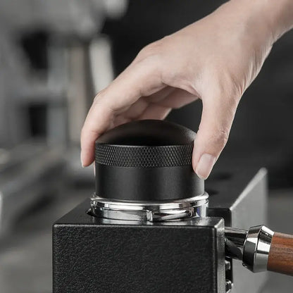 Modern black espresso needle distributor with black textured matte finish and metallic ring base for coffee grounds by decorbites