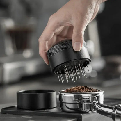 Modern black espresso needle distributor with textured grip and fine metal prongs for coffee grounds decorbites espresso needle