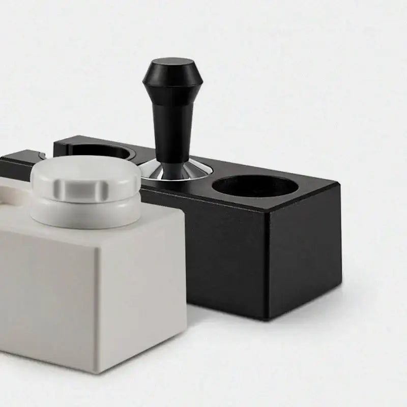 Modern black espresso tamper station featuring a matte finish black metal decorbites espresso tamper with ergonomic handle