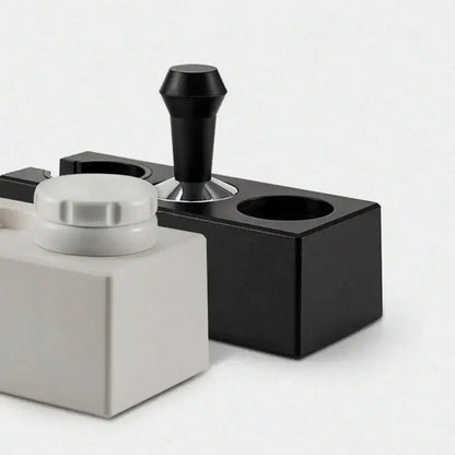 Modern black espresso tamper station featuring a matte finish black metal decorbites espresso tamper with ergonomic handle