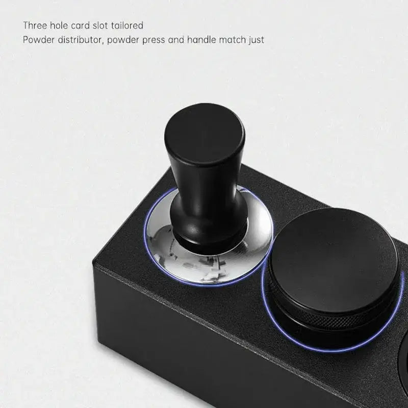 Modern black espresso tamper with sleek cylindrical handle and polished base on decorbites espresso tamper station