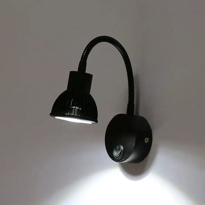Modern black finish metal shade wall lamp with flexible arm and adjustable head providing warm white LED light