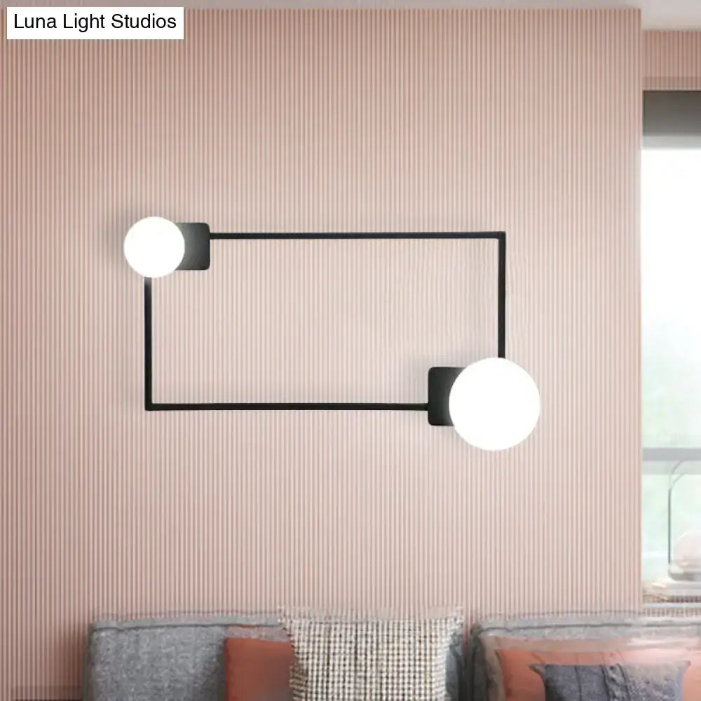 Modern black finish metal wall sconce with two white glass globe shades for bedroom lighting