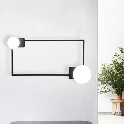 Modern black finish rectangular wall sconce with two white glass globe bulbs for bedroom lighting