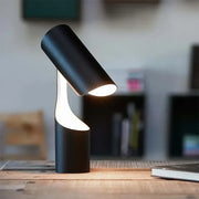 Modern black foldable desk lamp with sleek cylindrical design and warm light from curved base ideal for study and bedroom decorbites black foldable