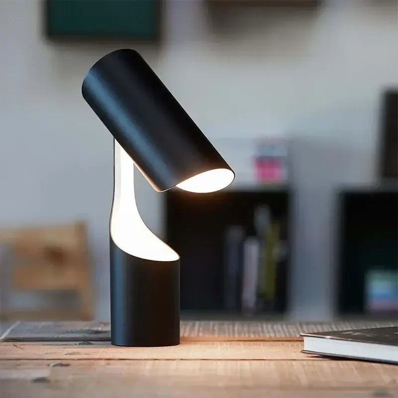 Modern black foldable desk lamp with sleek cylindrical design and warm light from curved base ideal for study and bedroom decorbites black foldable