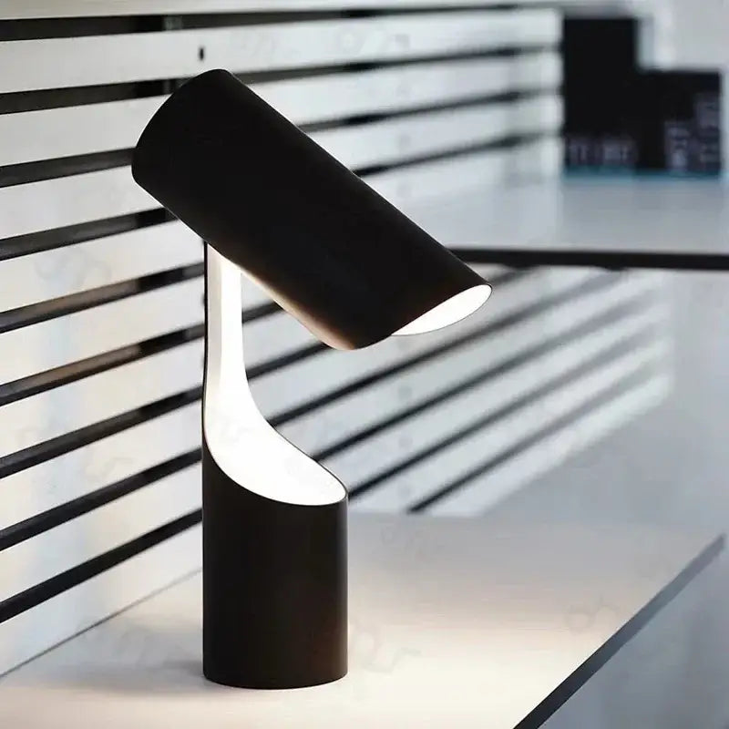 Modern black foldable desk lamp with a sleek cylindrical design and illuminated white inner curve for study and bedroom use
