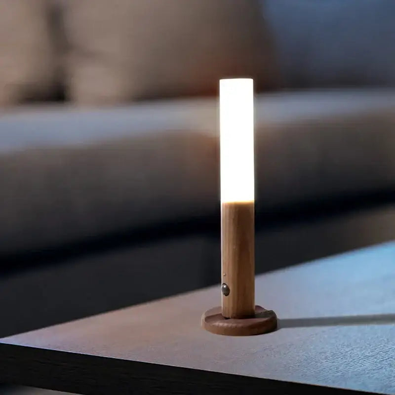 A modern black frosted glass night light corridor wall sconce with a sleek bodysense led rechargeable design and wooden base